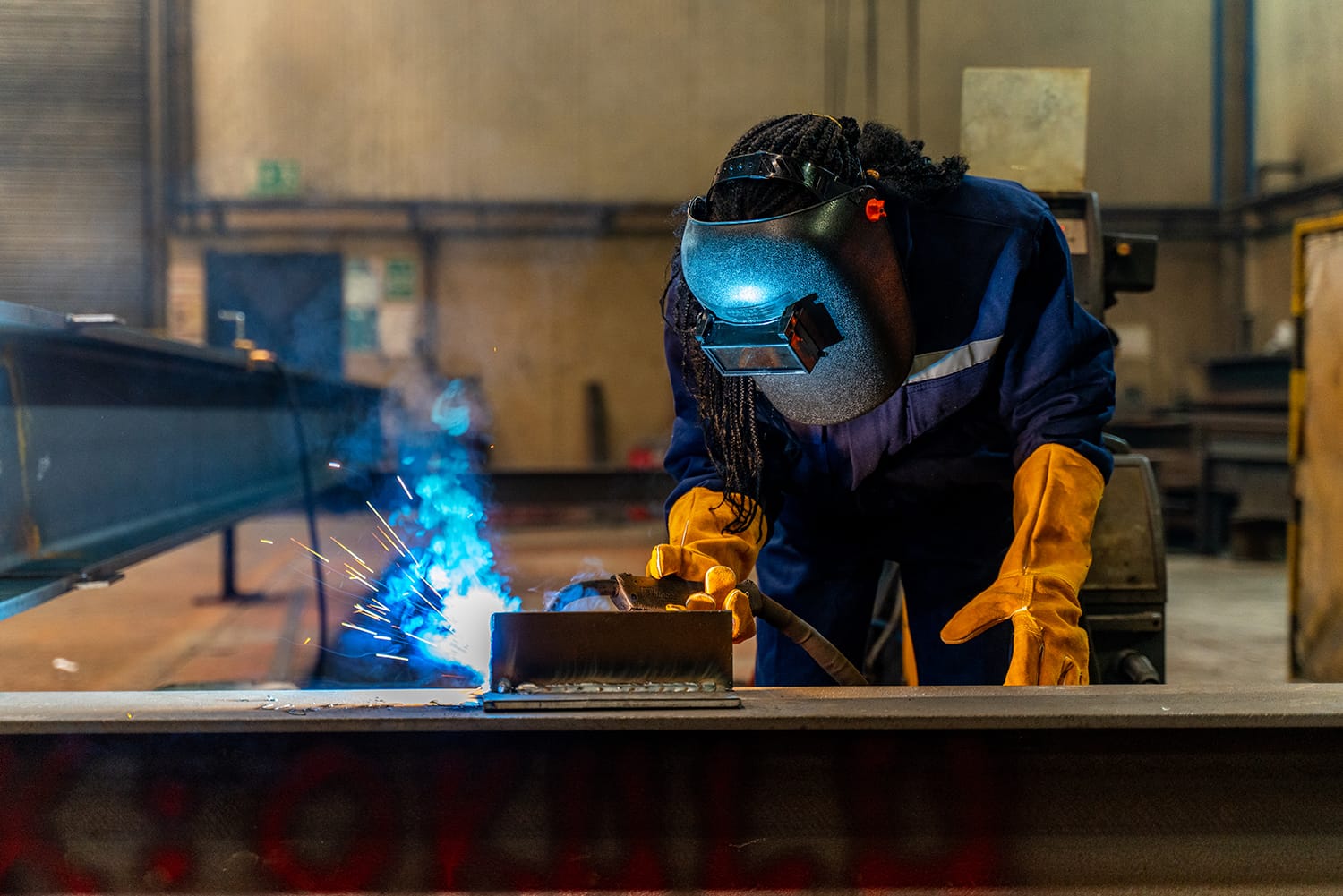 apprentice learning how to weld metal