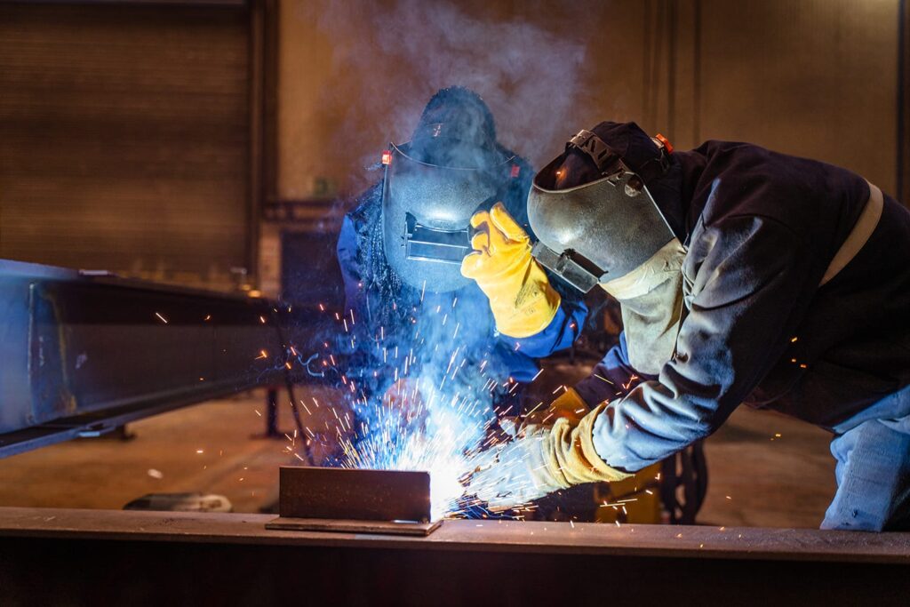 two apprentices working on welding skills