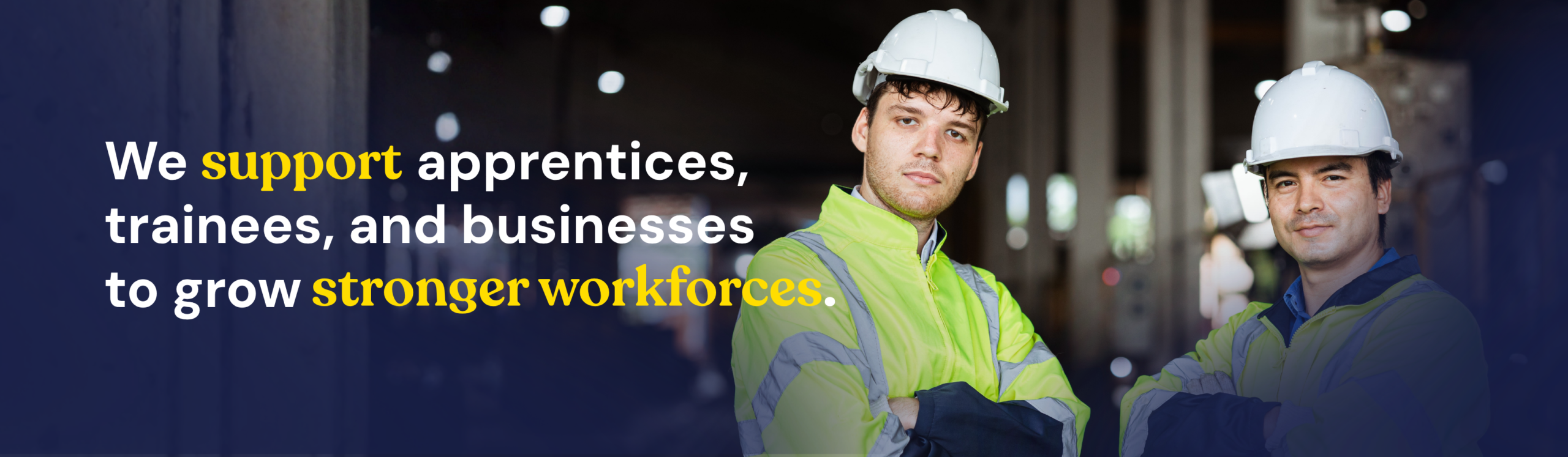 Two construction workers wearing hard hats and high-visibility vests, with support by Smart Apprenticeship Solutions, facilitated by Smart Apprenticeship Solution.